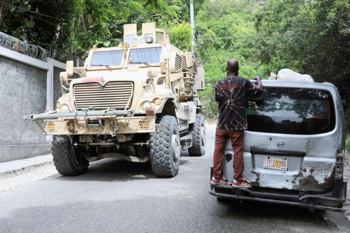 2025 07 24 Kenyan MSS cops in armored car patroling streets in Haiti AP Odelyne Joseph