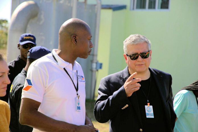 Jean-Mary Georges Junior, exec dir of UTE left leads an IDB official around Caracol industrial park in Jan 2023